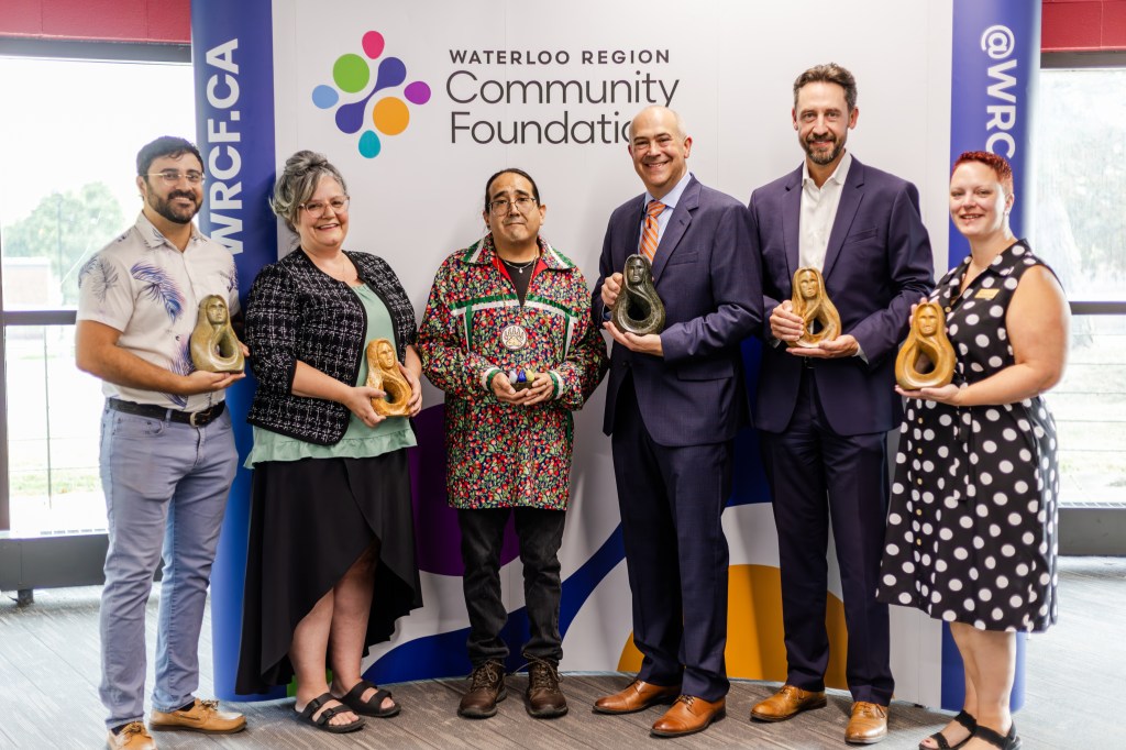 Sam Nabi posing with other award winners at the 2025 WRCF awards